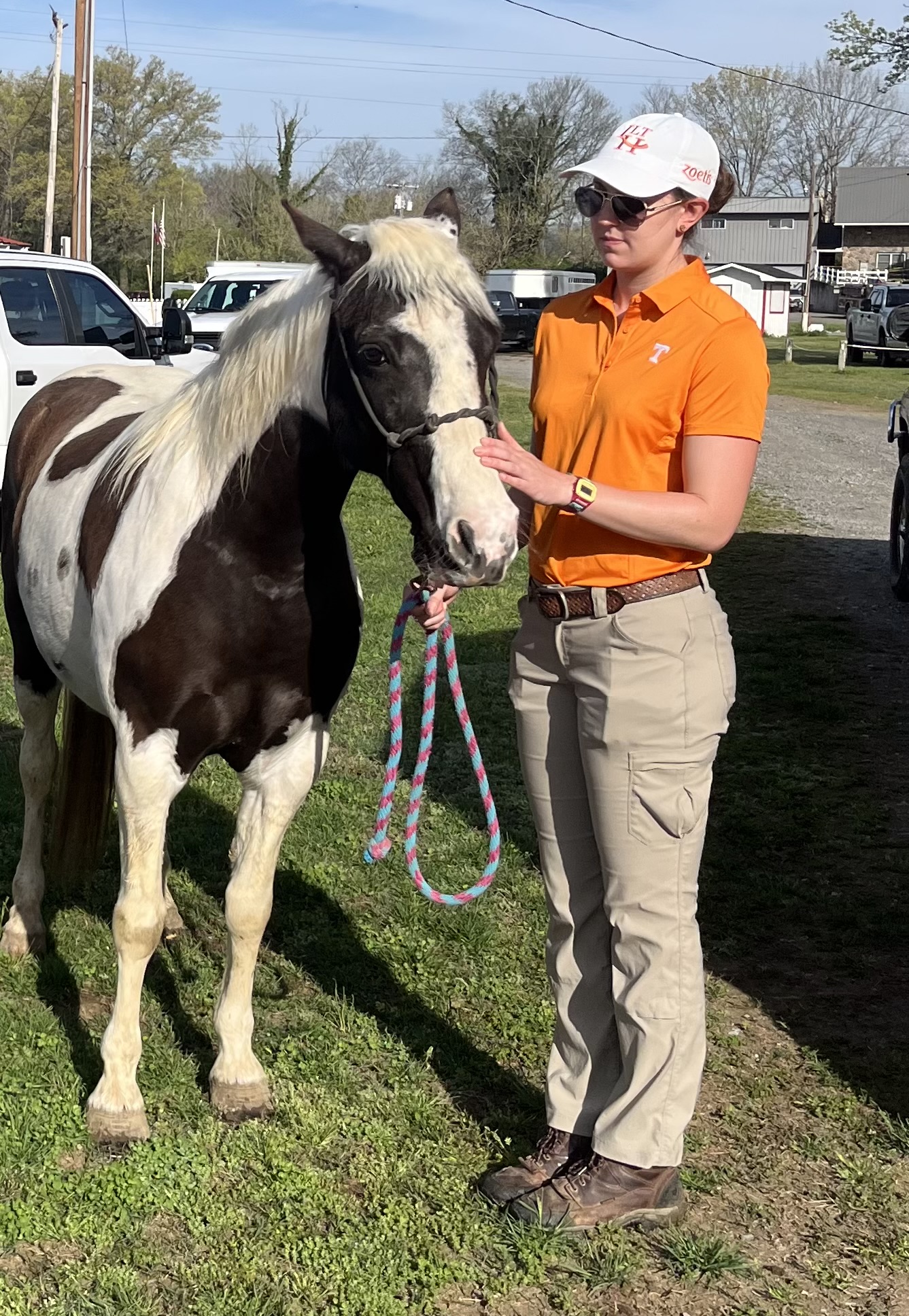 Student holding a black and white paint.