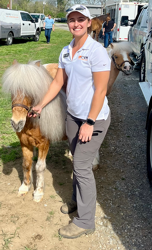 A UTCVM student holding a pony after the storm.