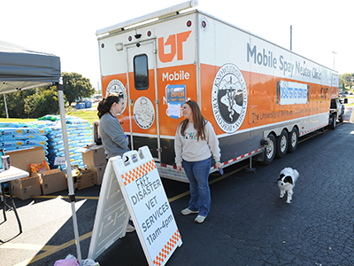 Owner and dog checking in at the Mobile UTCVM trailer after the storm.