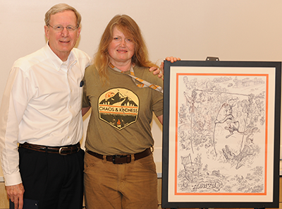r. Thompson with Kim Abney, artist who 
created the original artwork gifted to him by 
the college.