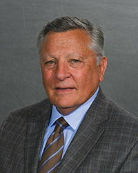 Robert DeNovo in gray suit in headshot.
