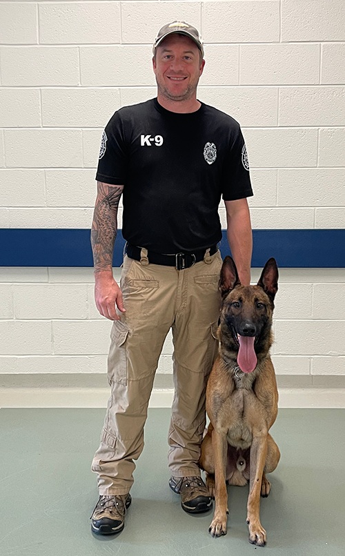 Metro-Nashville Officer Steven Meador waits with K-9 Tito at UTCVM before his laparoscopic-assisted prophylactic gastropexy surgery.