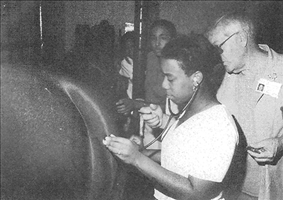 During her summer internship program, Melady Malone of Memphis, examines a horse under the supervision of veterinary dean, Dr. Mike Shires.