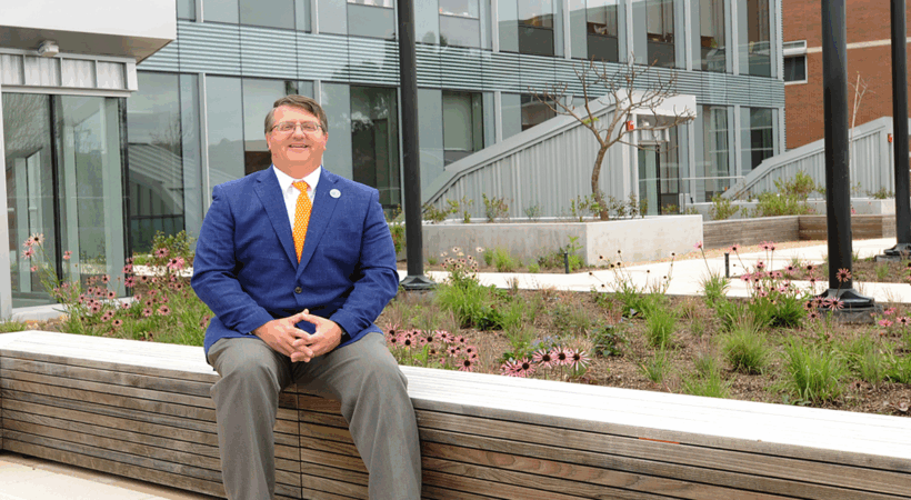 Dr Plummer sitting in the open area of the new ANR building.